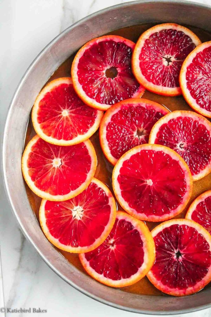 blood orange slices layered over brown sugar and melted butter in a cake pan