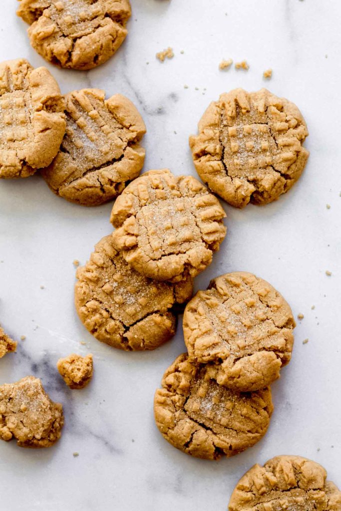 a few peanut butter cookies scattered on a white surface