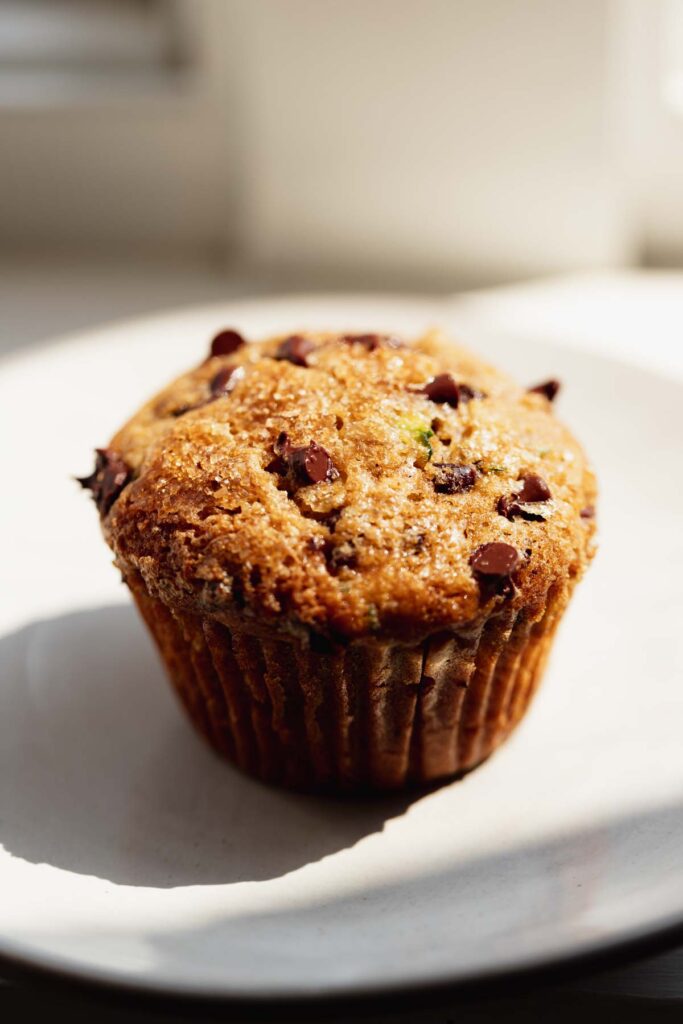 a zucchini muffin with chocolate chips on a plate